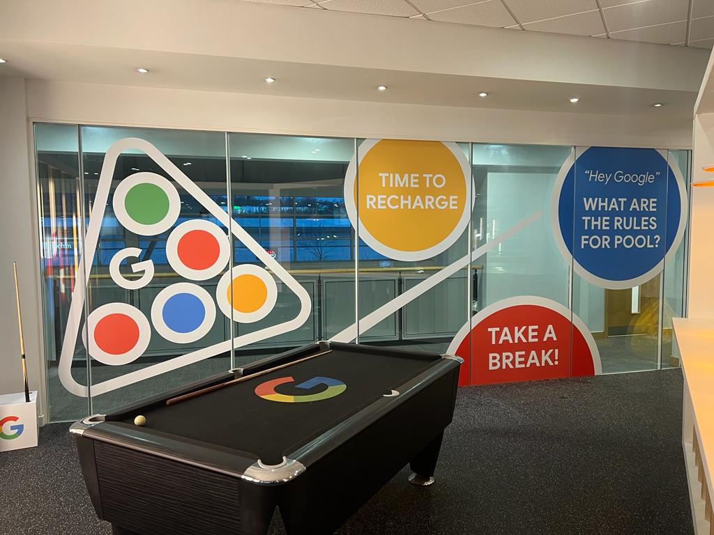 Google office breakout area with branded pool table and colourful wall graphics